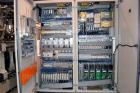 Used Uniloy Milacron Alkam Stretch Blow Molding Machine, Model BM-4. (4) Blow cavities/mould, 130mm distance between cavities. Unit includes an infeed system with a hopper, elevator, orienter, and in...