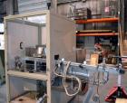 Used Uniloy Milacron Alkam Stretch Blow Molding Machine, Model BM-4. (4) Blow cavities/mould, 130mm distance between cavities. Unit includes an infeed system with a hopper, elevator, orienter, and in...