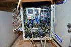 Used Uniloy Milacron Alkam Stretch Blow Molding Machine, Model BM-4. (4) Blow cavities/mould, 130mm distance between cavities. Unit includes an infeed system with a hopper, elevator, orienter, and in...