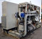 Used Uniloy Milacron Alkam Stretch Blow Molding Machine, Model BM-5. (5) Blow cavities/mould, 105mm distance between cavities. Unit includes an infeed system with a hopper, elevator, orienter, and in...
