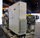 Used Uniloy Milacron Alkam Stretch Blow Molding Machine, Model BM-5. (5) Blow cavities/mould, 105mm distance between cavities. Unit includes an infeed system with a hopper, elevator, orienter, and in...