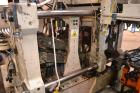 Used Uniloy Milacron Alkam Stretch Blow Molding Machine, Model BM-5. (5) Blow cavities/mould, 105mm distance between cavities. Unit includes an infeed system with a hopper, elevator, orienter, and in...