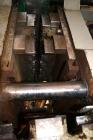 Used Uniloy Milacron Alkam Stretch Blow Molding Machine, Model BM-5. (5) Blow cavities/mould, 105mm distance between cavities. Unit includes an infeed system with a hopper, elevator, orienter, and in...