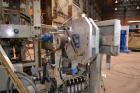 Used Uniloy Milacron Alkam Stretch Blow Molding Machine, Model BM-5. (5) Blow cavities/mould, 105mm distance between cavities. Unit includes an infeed system with a hopper, elevator, orienter, and in...