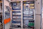 Used Uniloy Milacron Alkam Stretch Blow Molding Machine, Model BM-5. (5) Blow cavities/mould, 105mm distance between cavities. Unit includes an infeed system with a hopper, elevator, orienter, and in...