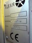 Used Uniloy Milacron Alkam Stretch Blow Molding Machine, Model BM-5. (5) Blow cavities/mould, 105mm distance between cavities. Unit includes an infeed system with a hopper, elevator, orienter, and in...