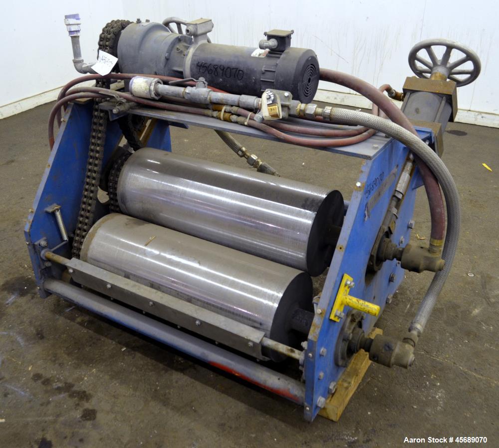 Used APV Chill Roll Stand. (2) Approximate 12" diameter x 32" wide chrome plated cored rolls. (1) Fixed, (1) manually adjustable. Driven by a 1.5hp, 180 volt, 1750 rpm DC gear motor, ratio 129.7 to 1...