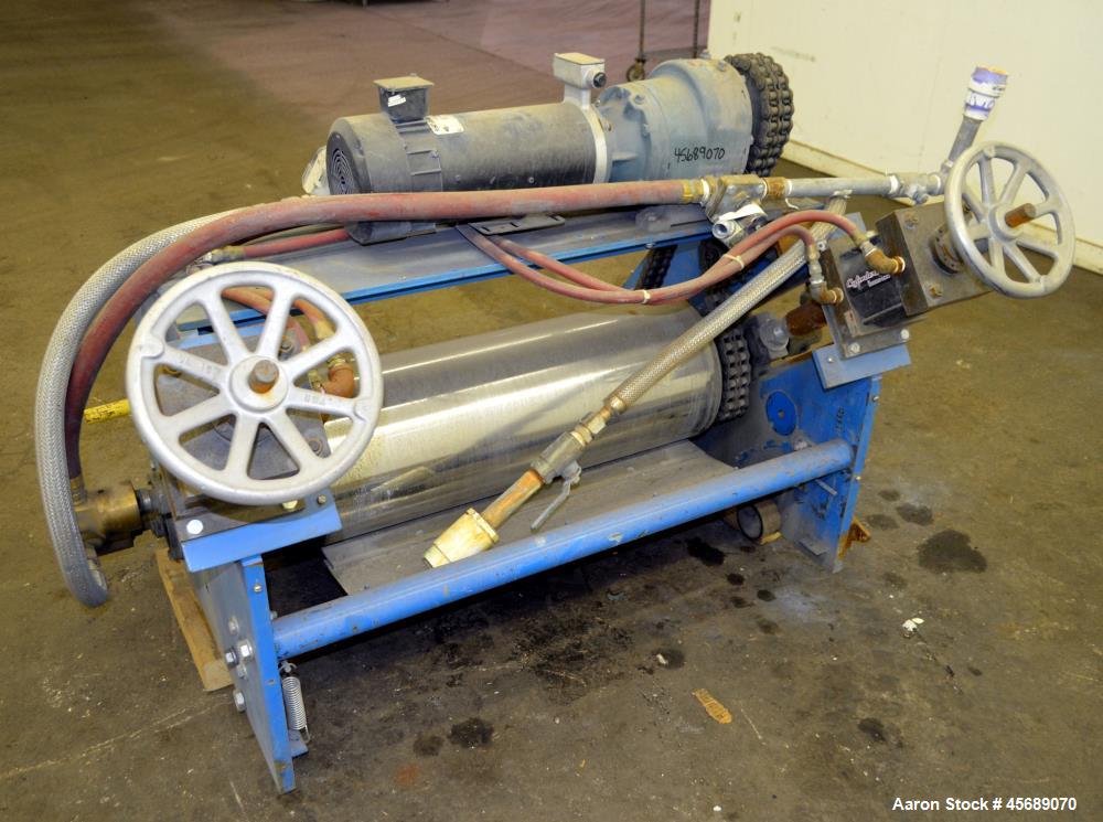 Used APV Chill Roll Stand. (2) Approximate 12" diameter x 32" wide chrome plated cored rolls. (1) Fixed, (1) manually adjustable. Driven by a 1.5hp, 180 volt, 1750 rpm DC gear motor, ratio 129.7 to 1...