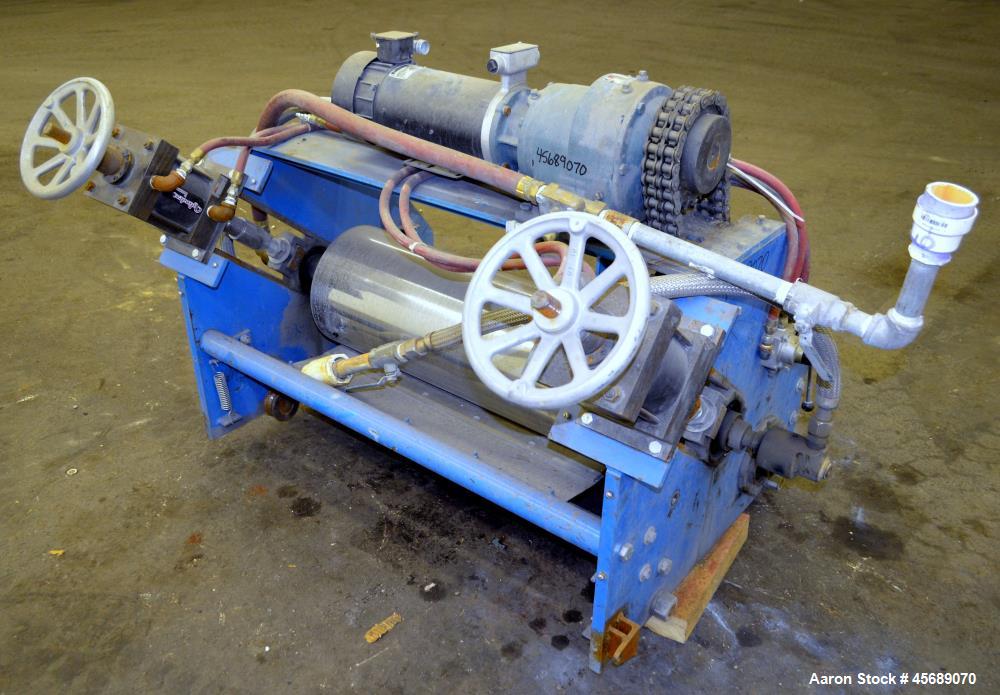 Used APV Chill Roll Stand. (2) Approximate 12" diameter x 32" wide chrome plated cored rolls. (1) Fixed, (1) manually adjustable. Driven by a 1.5hp, 180 volt, 1750 rpm DC gear motor, ratio 129.7 to 1...