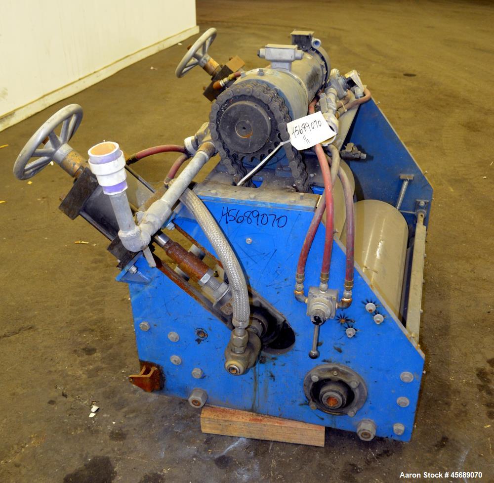 Used APV Chill Roll Stand. (2) Approximate 12" diameter x 32" wide chrome plated cored rolls. (1) Fixed, (1) manually adjustable. Driven by a 1.5hp, 180 volt, 1750 rpm DC gear motor, ratio 129.7 to 1...