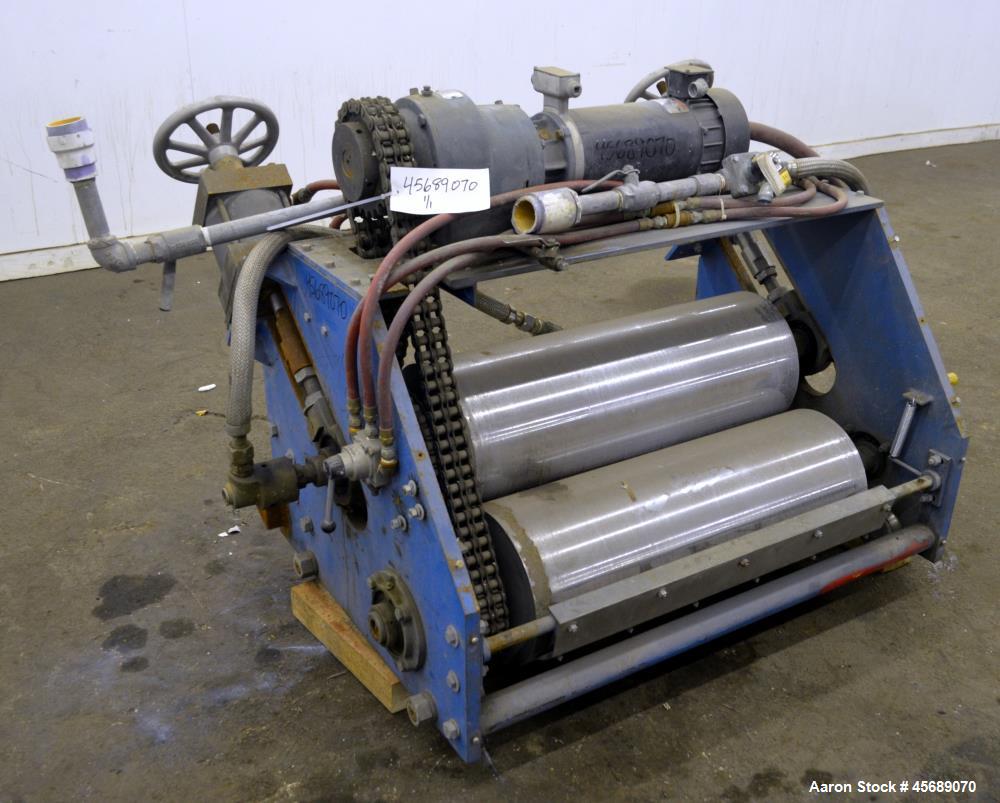Used APV Chill Roll Stand. (2) Approximate 12" diameter x 32" wide chrome plated cored rolls. (1) Fixed, (1) manually adjustable. Driven by a 1.5hp, 180 volt, 1750 rpm DC gear motor, ratio 129.7 to 1...