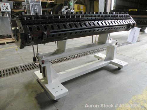 Used Titan Sheet Die, 78" wide. Approximate 1-5/8" diameter back center feed. Mounted on a cart with casters.