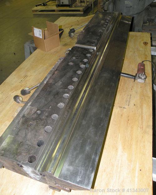 Used Titan Sheet Die, 78" wide. Approximate 1-5/8" diameter back center feed. Mounted on a cart with casters.