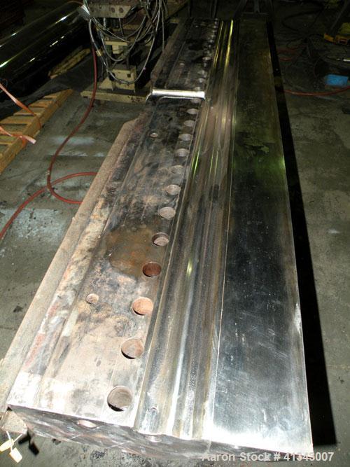 Used Titan Sheet Die, 78" wide. Approximate 1-5/8" diameter back center feed. Mounted on a cart with casters.