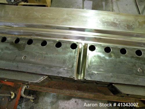 Used Titan Sheet Die, 78" wide. Approximate 1-5/8" diameter back center feed. Mounted on a cart with casters.