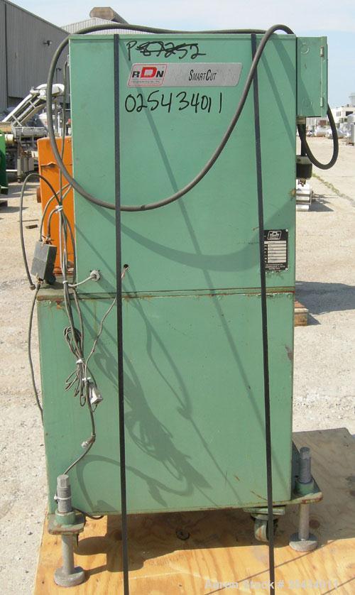 Used RDN Smartcut Fly Knife Cutter, Model SC2.  2 1/4" diameter opening, single blade, driven by an approximate 2 hp motor. Includes a control panel.  Mounted on casters.