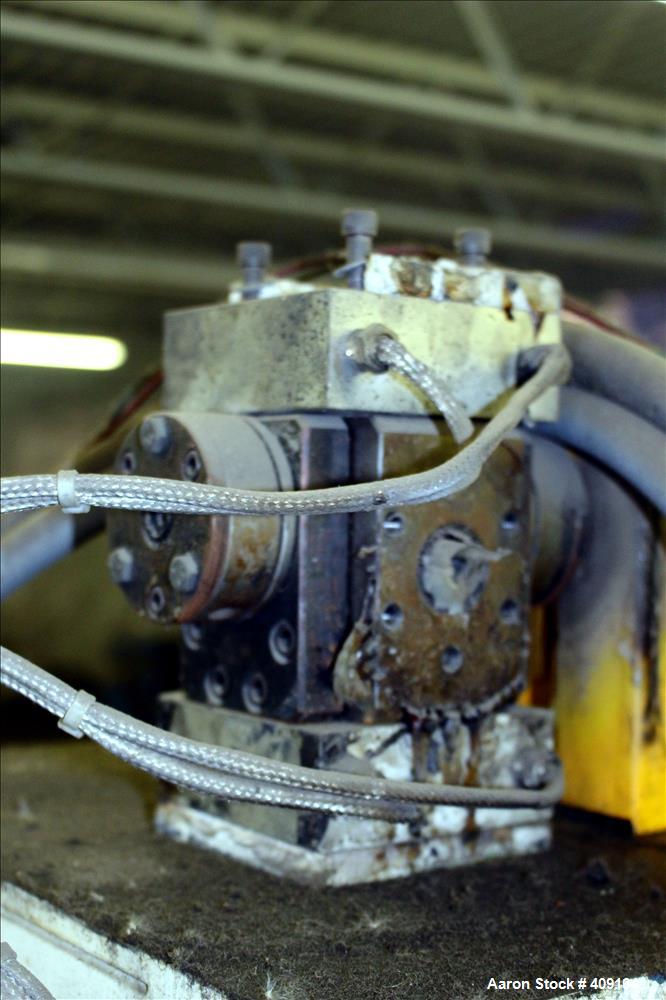 Used Zenith Melt Pump, Model 60-20000-2174-4. Approximate 1" diameter inlet/outlet. Driven by a 1 hp, 3/60/460 volt, 1750 rpm SC motor with reducer, ratio 52.69:1. Mounted on a frame with casters.