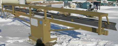 USED: Royal Machine dual lane dump table, model 158. (2) 6" wide x 236" long pneumatically operated stainless steel rails. Mounted on a carbon steel frame. Built 1996.
