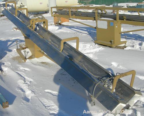USED: Royal Machine dual lane dump table, model 158. (2) 6" wide x 236" long pneumatically operated stainless steel rails. Mounted on a carbon steel frame. Built 1997.