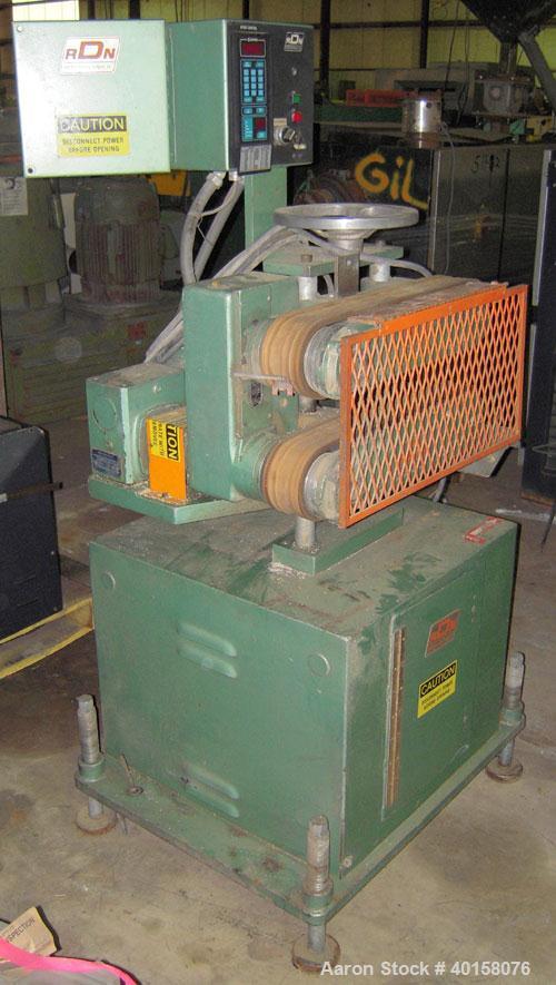 Used RDN belt puller, model 218-3. 3" wide x 18" long contact length belts, manually adjustable. Driven by a 1 1/2 hp motor. Includes operator panel.