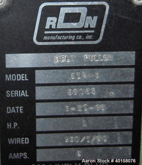Used RDN belt puller, model 218-3. 3" wide x 18" long contact length belts, manually adjustable. Driven by a 1 1/2 hp motor. Includes operator panel.