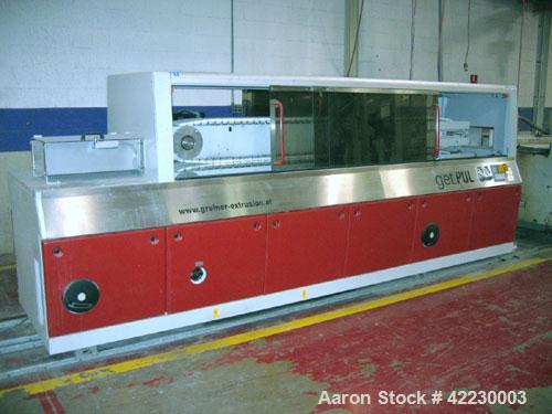 Used Greiner Cleated Belt Puller, Model 30/9-300. (2) 12" wide x 108" long cleated belts. Each belt driven by a 3 kw gear motor. Includes a control panel. Built 2006.