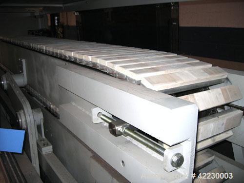 Used Greiner Cleated Belt Puller, Model 30/9-300. (2) 12" wide x 108" long cleated belts. Each belt driven by a 3 kw gear motor. Includes a control panel. Built 2006.