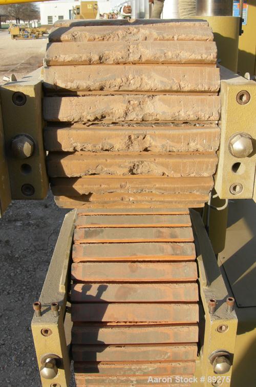 Used Royal Machine Cleated Belt Puller, Model 067. (2) 10" wide x 12' long contact area. Pneumatically adjustable belts. Each belt driven by a 2 hp, 640 volt, 2500 rpm DC gearmotor. (1 belt missing m...
