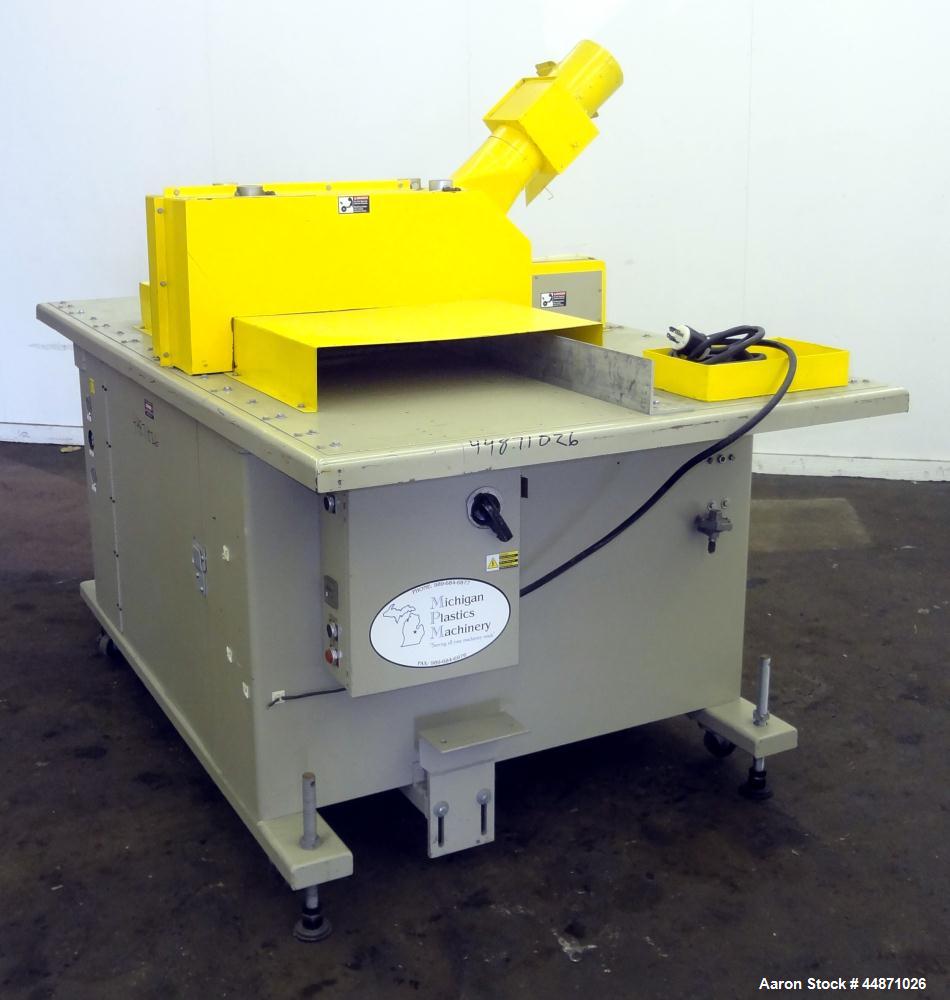 Used Michigan Plastics Machinery Traveling Chop-Cut Saw.  Blade driven by a 1.5 hp, 3/60/208-230/460 volt, 3500 rpm motor.  Mounted on a base with adjustable legs.  No manufacturer's tag.