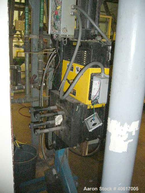 Used Dynisco 4.5" Hydraulic Screen Changer. Includes a stand and hydraulic pump.
