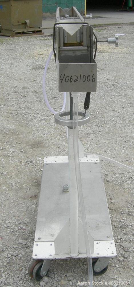 Used Genca Water Bath, stainless steel. 4" wide x 60" long x 3" deep. Mounted on a carbon steel base with casters.