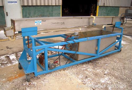 Used Waterbath, 304 stainless steel. 12" wide x 156" long x 7 1/2" deep. Includes a pump and a holding tank. Mounted on a carbon steel frame with wheels.