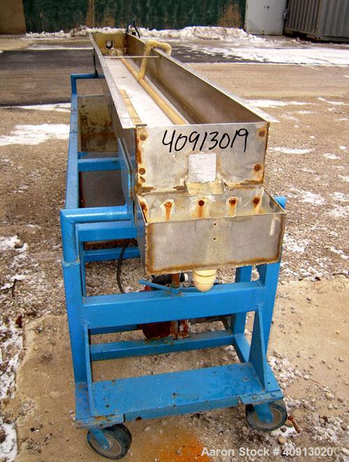 Used Waterbath, 304 stainless steel. 12" wide x 156" long x 7 1/2" deep. Includes a pump and a holding tank. Mounted on a carbon steel frame with wheels.