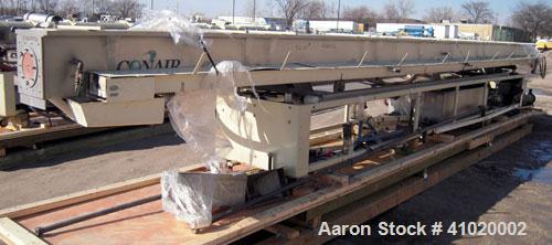 Used Conair Water Cooling Tank, Model MCB-30-4, 304 stainless steel. 12" wide x 360" long x 12" deep. Includes tank, pumps and heat exchanger. Mounted on a carbon steel frame on casters.