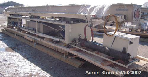 Used Conair Water Cooling Tank, Model MCB-30-4, 304 stainless steel. 12" wide x 360" long x 12" deep. Includes tank, pumps and heat exchanger. Mounted on a carbon steel frame on casters.