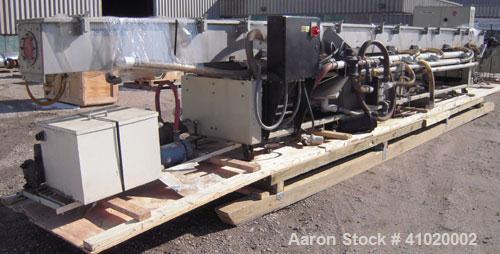 Used Conair Water Cooling Tank, Model MCB-30-4, 304 stainless steel. 12" wide x 360" long x 12" deep. Includes tank, pumps and heat exchanger. Mounted on a carbon steel frame on casters.
