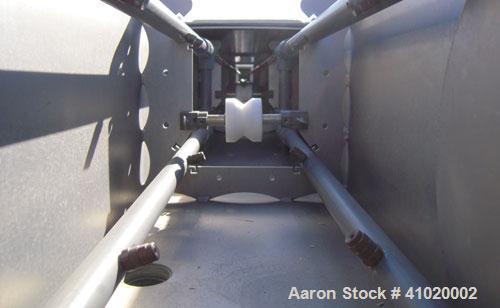 Used Conair Water Cooling Tank, Model MCB-30-4, 304 stainless steel. 12" wide x 360" long x 12" deep. Includes tank, pumps and heat exchanger. Mounted on a carbon steel frame on casters.