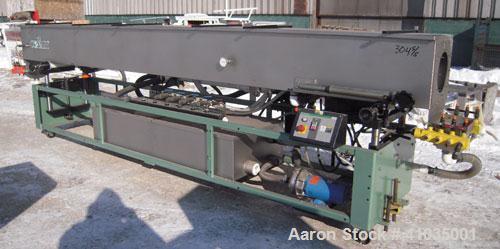 Used Conair Spray Cooling Tank, Model WCB-16-8, 304 Stainless Steel. 16" wide x 192" long x 16" deep. 3 piece top cover, (4) spray pipes with nozzles. Includes a pump and holding tank. Mounted on a c...