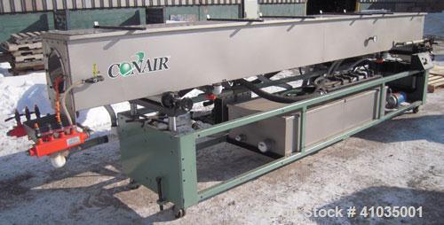 Used Conair Spray Cooling Tank, Model WCB-16-8, 304 Stainless Steel. 16" wide x 192" long x 16" deep. 3 piece top cover, (4) spray pipes with nozzles. Includes a pump and holding tank. Mounted on a c...