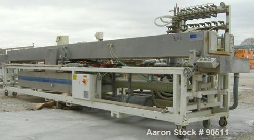 Used: Extrusion Services Inc.(ESI) spray cooling tank, 304 stainless steel. 26" wide x 11" deep x 20'4" long.(3) sections of 4' long covers. Includes holding tank,(2)pumps, filter, heat exchanger,and...