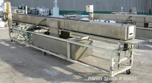 Used: Extrusion Services Inc.(ESI) spray cooling tank, 304 stainless steel. 16" wide x 11" deep x 20' long.(4) section top cover. Includes holding tank,pump, heat exchanger,and control panel. Mounted...