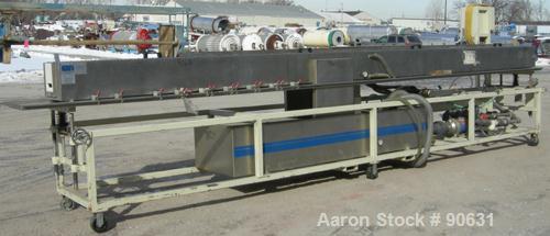 Used: Extrusion Services Inc.(ESI) spray cooling tank, 304 stainless steel. 16" wide x 11" deep x 20' long.(4) section top cover. Includes holding tank,pump, heat exchanger,and control panel. Mounted...