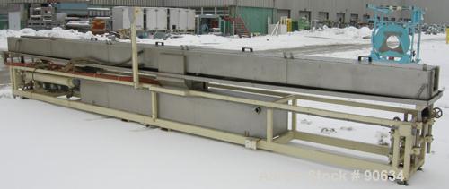 Used: Extrusion Services Inc.(ESI) spray cooling tank, 304 stainless steel. 16" wide x 11" deep x 25' long.(4) section top cover (1) missing. Includes holding tank,pump, heat exchanger,and control pa...