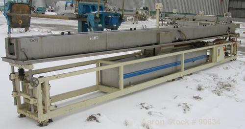 Used: Extrusion Services Inc.(ESI) spray cooling tank, 304 stainless steel. 16" wide x 11" deep x 25' long.(4) section top cover (1) missing. Includes holding tank,pump, heat exchanger,and control pa...
