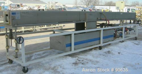 Used: Extrusion Services Inc.(ESI) spray cooling tank, 304 stainless steel. 16" wide x 11" deep x 20' long.(4) section top cover. Includes holding tank,pump, heat exchanger,and control panel. Mounted...
