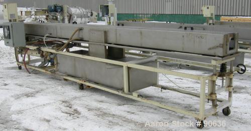 Used: Extrusion Services Inc.(ESI) spray cooling tank, 304 stainless steel. 16" wide x 11" deep x 20' long.(4) section top cover. Includes holding tank,pump, heat exchanger,and control panel. Mounted...