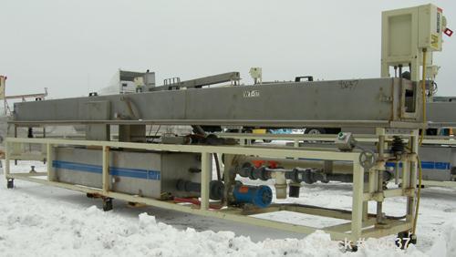 Used: Extrusion Services Inc.(ESI) spray cooling tank, 304 stainless steel. 16" wide x 11" deep x 20' long.(4) section top cover. Includes holding tank,pump, heat exchanger,and control panel. Mounted...