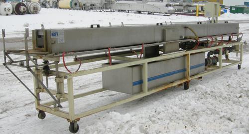 Used: Extrusion Services Inc.(ESI) spray cooling tank, 304 stainless steel. 16" wide x 11" deep x 20' long.(4) section top cover. Includes holding tank,pump, heat exchanger,and control panel. Mounted...