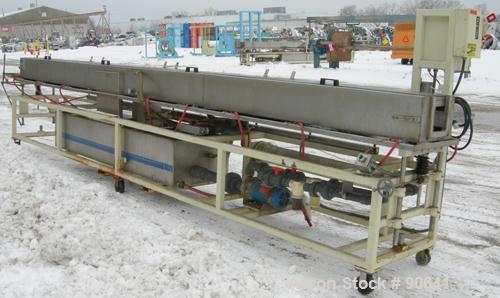 Used: Extrusion Services Inc.(ESI) spray cooling tank, 304 stainless steel. 16" wide x 11" deep x 20' long.(4) section top cover. Includes holding tank,pump, heat exchanger,and control panel. Mounted...