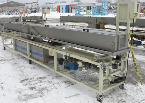 Used: Extrusion Services Inc.(ESI) spray cooling tank, 304 stainless steel. 16" wide x 11" deep x 20' long.(4) section top cover. Includes holding tank,pump, heat exchanger,and control panel. Mounted...